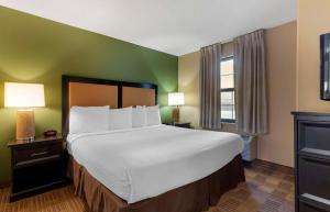 a hotel room with a large bed and a window at Extended Stay America Suites - Oakland - Alameda Airport in Alameda