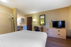 a bedroom with a bed and a flat screen tv at Extended Stay America Suites - Stockton - March Lane in Stockton