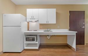 a kitchen with a sink and a white refrigerator at Extended Stay America Suites - Stockton - March Lane in Stockton