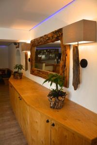 a wooden counter with a mirror on a wall at Pension Milan in Zell am See