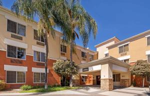 a building with a palm tree in front of it at Extended Stay America Suites - Los Angeles - Glendale in Glendale