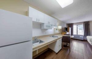 a kitchen with white cabinets and a sink in a room at Extended Stay America Suites - Los Angeles - Glendale in Glendale