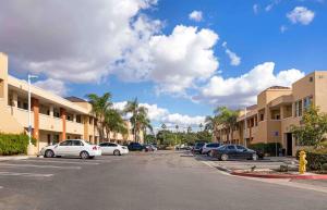 a parking lot with cars parked in front of buildings at Extended Stay America Suites - Orange County - Irvine Spectrum in Irvine