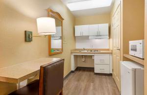 a small kitchen with a table and a sink at Extended Stay America Suites - Orange County - Irvine Spectrum in Irvine