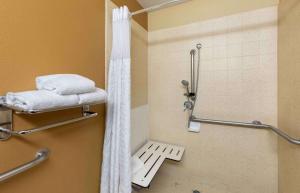 a shower in a bathroom with a white shower curtain at Extended Stay America Suites - Orange County - Irvine Spectrum in Irvine