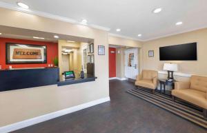 a lobby with two chairs and a flat screen tv at Extended Stay America Suites - Orange County - Brea in Brea
