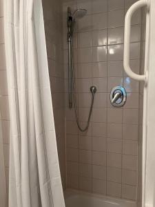 a bathroom with a shower with a shower curtain at Ferienwohnung West 2 in Stuttgart
