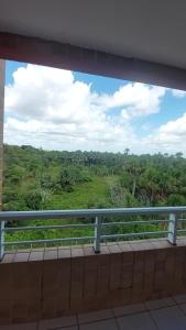 a view from a balcony looking out at a forest at Gran Lençóis Flat Barreirinhas in Barreirinhas