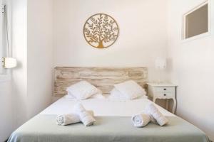 a bedroom with a bed with two towels on it at Lisbon Garden Stays, with BBQ, Easy Parking near Tejo, Fast Access to Alfama & Downtown in Lisbon