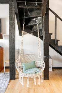 a hanging chair with a pillow in a room at Cozy Haven Retreat in Lisbon