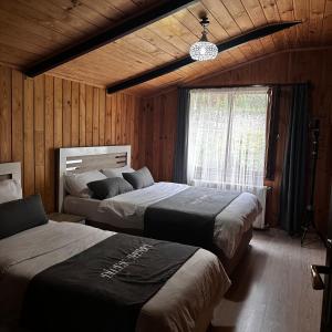 a bedroom with two beds and a window at Dilek Apart in Uzungol