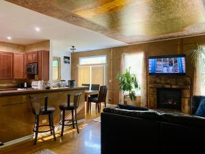 a kitchen and living room with a couch and a fireplace at Spacious Fully-Equipped Home in Algonquin