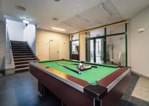 a pool table in the middle of a room at Apartament Navy Blue z tarasem in Serock