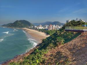 a view of a beach from a hill with a bridge at Guarujá Hostel in Guarujá