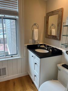 a bathroom with a sink and a window at The Centerboard Nantucket in Nantucket