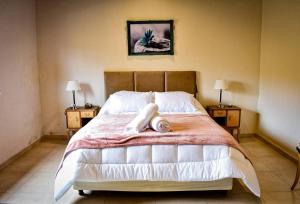 a bedroom with a large bed with two night stands at La Concepción in Vista Flores