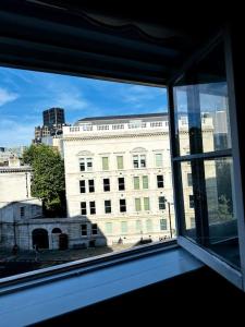 a view of a building from a window at 2Bed Apartment Farringdon St Paul Long Stay Discounts By Cozystays in London