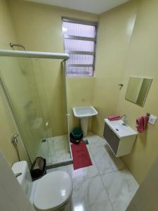 a bathroom with a shower and a sink and a toilet at Copacabana Posto 6 até 3 pessoas in Rio de Janeiro
