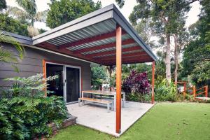 a pergola with a bench on a patio at NRMA South West Rocks Holiday Park in South West Rocks