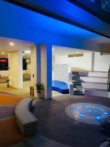 a room with a bed and a staircase with blue lights at RumaKL at TR Residence Titiwangsa Sentral in Kuala Lumpur