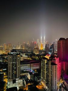 a city skyline at night with lit up buildings at RumaKL at TR Residence Titiwangsa Sentral in Kuala Lumpur
