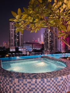 a swimming pool with a city skyline in the background at RumaKL at TR Residence Titiwangsa Sentral in Kuala Lumpur