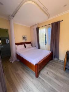 a large bed in a room with a window at SEGA LODGE RESORT in Sega