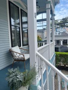 a porch with a chair on a house at The Centerboard Nantucket in Nantucket