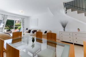 a living room with a glass table and chairs at Antonia's Palace Rooftop Jacuzzi Stunning View in Paphos City