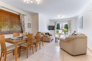 a dining room and living room with a table and chairs at Antonia's Palace Rooftop Jacuzzi Stunning View in Paphos City