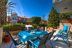 a blue table and chairs on a patio at Antonia's Palace Rooftop Jacuzzi Stunning View in Paphos City