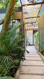 a walkway in a building with plants at Poblado Muuk Hotel Boutique Campestre in Medellín