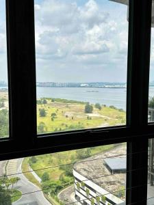 a view of the ocean from a window at Sun Seaview Country Garden Danga Bay Luxury Condominium in Johor Bahru