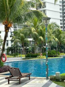 a bench and a light pole next to a swimming pool at Sun Seaview Country Garden Danga Bay Luxury Condominium in Johor Bahru