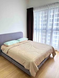 a bed in a bedroom with a large window at Sun Seaview Country Garden Danga Bay Luxury Condominium in Johor Bahru
