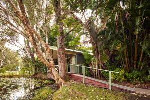 a house with trees in front of it at NRMA Darlington Beach Holiday Resort in Arrawarra
