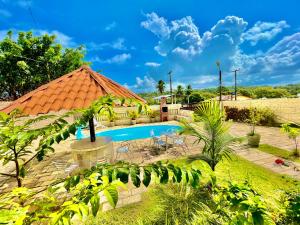 a resort with a swimming pool in a yard at Casa Ilha de Itamaracá in Vila Velha