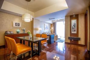 a dining room and living room with a table and chairs at The Imperial Mansion, Beijing - Marriott Executive Apartments in Beijing