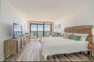 a bedroom with a bed and a view of the ocean at Soul Sanctuary-Direct oceanfront-Million dollars view-King bed-Free Parking-Self check-in in Myrtle Beach
