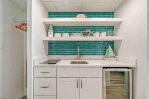 a kitchen with a sink and a green tile wall at Soul Sanctuary-Direct oceanfront-Million dollars view-King bed-Free Parking-Self check-in in Myrtle Beach +15 photos