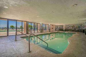 a large swimming pool in a large building with a swimming pool at Soul Sanctuary-Direct oceanfront-Million dollars view-King bed-Free Parking-Self check-in in Myrtle Beach