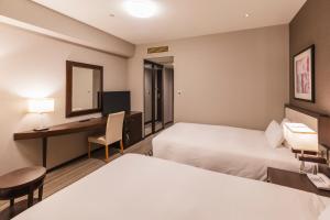 Postel nebo postele na pokoji v ubytování Hotel Sunroute Plaza Shinjuku