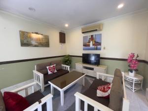 a living room with a couch and a table at Beatiful Afamosa Golf Resort Private villa with pool 3 rooms lot 1280 bumiputra only in Kampong Alor Gajah