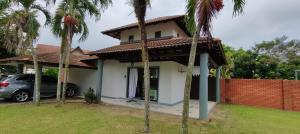 a house with a car parked in front of it at Beatiful Afamosa Golf Resort Private villa with pool 3 rooms lot 1280 bumiputra only in Kampong Alor Gajah