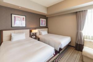 Postel nebo postele na pokoji v ubytování Hotel Sunroute Plaza Shinjuku