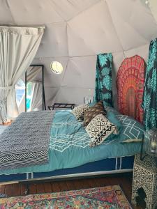 a bedroom with a bed in a tent at Manta Soul Jungle Geodome in Kealakekua