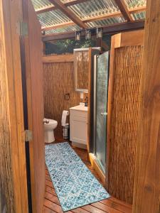 a small bathroom with a shower and a toilet at Manta Soul Jungle Geodome in Kealakekua