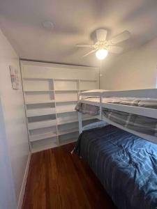 ein Schlafzimmer mit einem Etagenbett und einem Deckenventilator in der Unterkunft Cozy House on the hill in Tallahassee