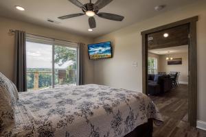 a bedroom with a bed and a large window at Broadview, River, Golf Course, Games, free Attraction Tickets, WIFI!!! in Kodak