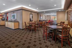 a restaurant with tables and chairs and a counter at TownePlace Suites by Marriott Las Vegas Henderson in Las Vegas